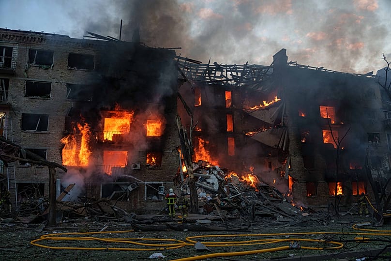 Rescue workers try to put out a fire at a residential building after a Russian strike on Kyiv, 24 May, 2026