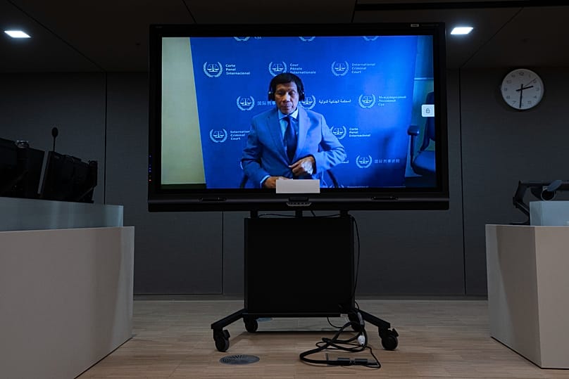 Former Philippine President Rodrigo Duterte is seen on a screen in the courtroom of the International Criminal Court in The Hague, 14 March, 2025