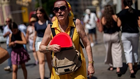 A woman fans herself during the most recent heatwave that hit Spain.