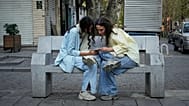 FILE - Two women use a smartphone in northern Tehran, Iran, Sept. 28, 2025. (AP Photo/Vahid Salemi, File)