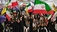 Government supporters hold Iranian flags and pictures of Iran's Supreme Leader, Ayatollah Mojtaba Khamenei, during a ceremony honoring the armed forces and those killed.