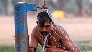 A man bathes at a public water tap near the River Ganges on a hot summer day in Prayagraj, India, Wednesday, May 27, 2026.