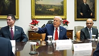 FILE. CEO of Dell, Michael Dell, left, and CEO of IBM, Arvind Krishna, right, as US President Donald Trump speaks during a roundtable at the White House, Dec. 2025