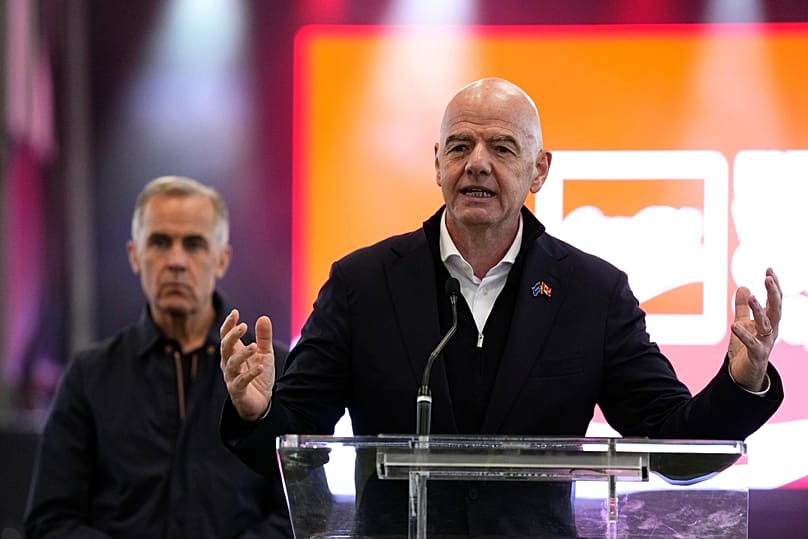 FIFA President Gianni Infantino speaks as Canada's Prime Minister Mark Carney looks on during a FIFA World Cup trophy tour event in Ottawa, 24 May 2026
