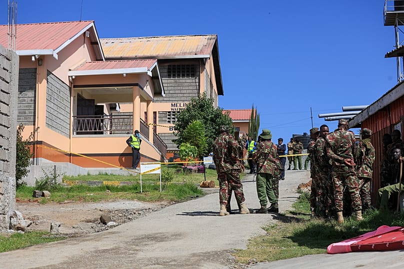 Police officers stand near the scene of an early morning fire outbreak at Utumishi Girls School in Gilgil, 28 May, 2026