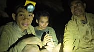 This image made from the video provided by Benz Norrased Palasing Seascout Diving shows the villagers who were trapped and found in a flooded cave in Xaisomboun province