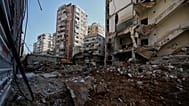 A bulldozer clears the rubble where a sports clothing shop was destroyed in a previous Israeli airstrike in Chiyah, 6 May, 2026