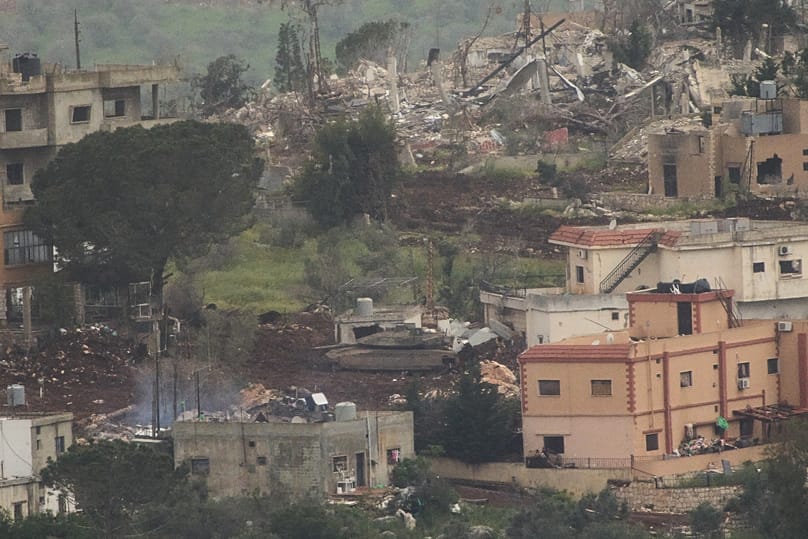 Israeli soldiers drive a tank inside a village in southern Lebanon, as seen from northern Israel, Tuesday, May 5, 2026.