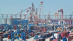 Shipping containers are stacked on a dock at a port in Nantong in eastern China's Jiangsu Province, Monday, May 1, 2023.