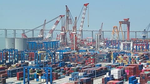 Shipping containers are stacked on a dock at a port in Nantong in eastern China's Jiangsu Province, Monday, May 1, 2023.