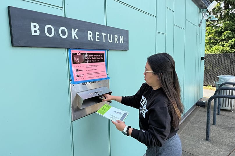 A voter drops off their ballot at a library in Portland, 19 May, 2026