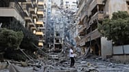 A man checks the site of destroyed buildings that were hit in Israeli airstrikes in the southern port city of Tyre