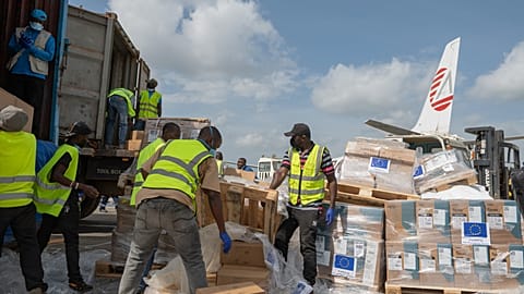 Workers offload medical and emergency supplies donated by European Union to support frontline workers in fighting Ebola upon arrival at the national airport in Bunia
