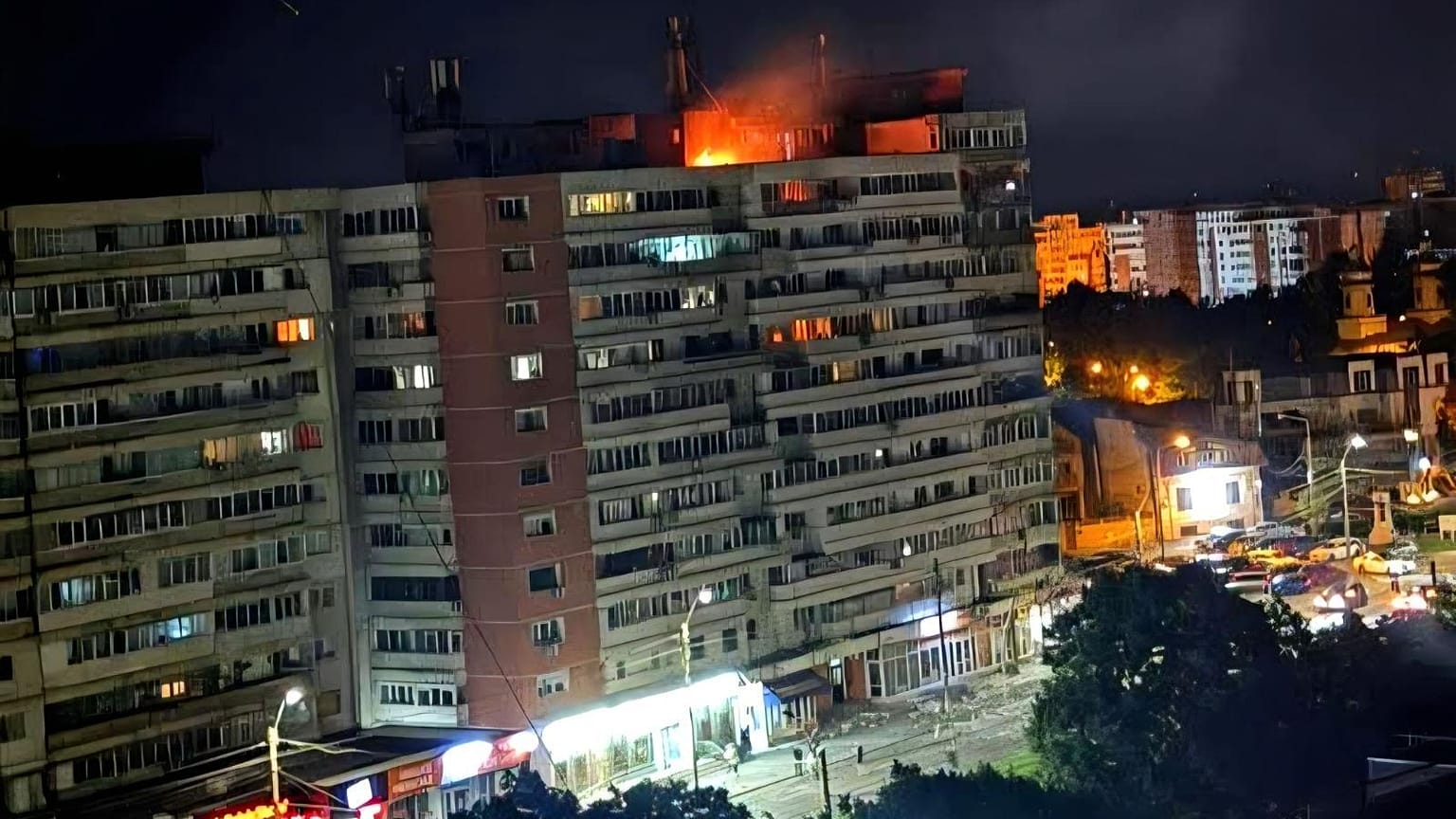 This photo released by Romania's Department for Emergency Situations shows a fire on top of a block of flats after a drone crash caused an explosion and fire on impact.