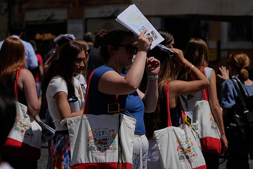 People attempting to shelter from the scortching sun in Rome on 26th May 2026