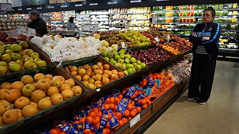 FILE - People shop at a grocery store in Schaumburg, Ill., Thursday, May 14, 2026. (AP Photo/Nam Y. Huh)
