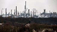 A chemical industrial park is seen behind residential buildings, in Gelsenkirchen, Germany, Wednesday, Feb. 12, 2025.