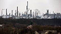 A chemical industrial park is seen behind residential buildings, in Gelsenkirchen, Germany, Wednesday, Feb. 12, 2025.