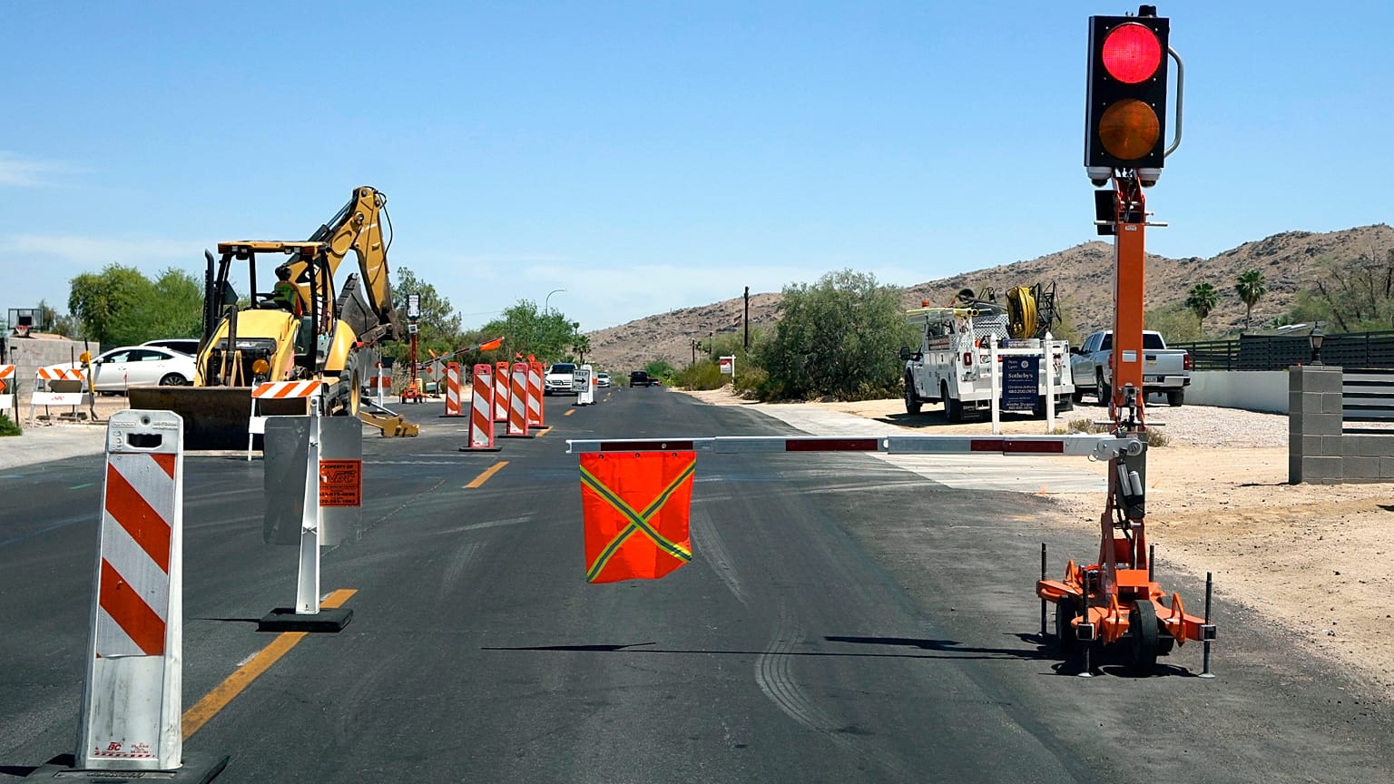 Two automated safety lights have replaced construction zone flaggers directing traffic at this road project, Tuesday, 21 April, 2026, in Phoenix.