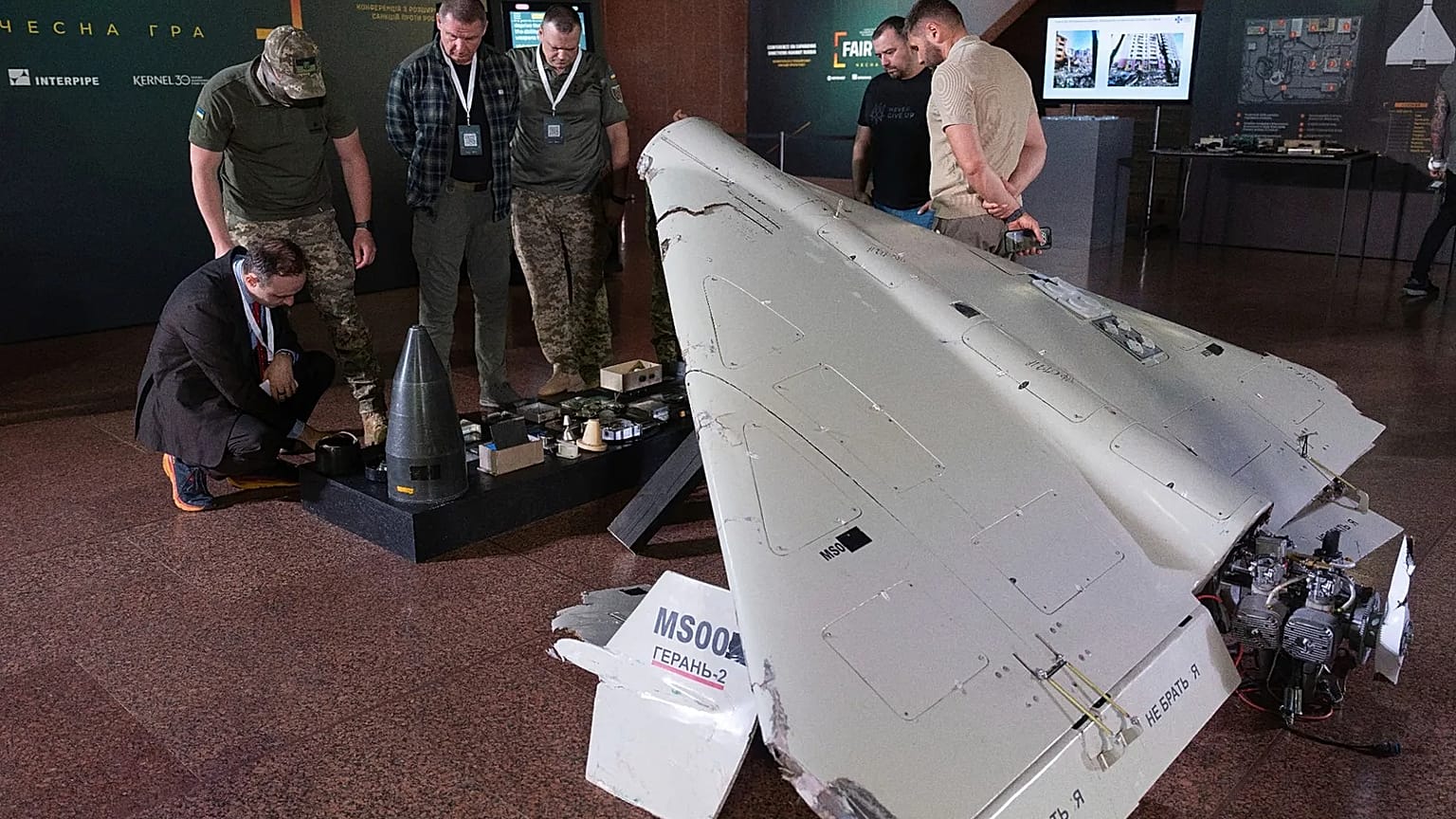 FILE: Visitors look at a damaged Iranian-made drone, Shahed, during the International Conference on Expanding Sanctions Against Russia in Kyiv, Ukraine, Friday, June 27, 2025