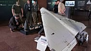 FILE: Visitors look at a damaged Iranian-made drone, Shahed, during the International Conference on Expanding Sanctions Against Russia in Kyiv, Ukraine, Friday, June 27, 2025