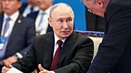 Russian President Vladimir Putin speaks with Russian Deputy Prime Minister Alexei Overchuk during the Eurasian Economic Union summit in Astana, 29 May 2026