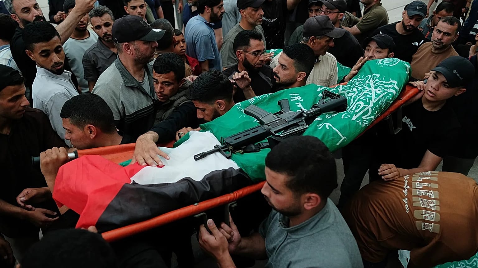 Palestinians carry the body of a Hamas militant, who was killed in an Israeli military strike, during his funeral at Al-Shafi'i Mosque in Gaza City, Thursday.