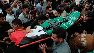 Palestinians carry the body of a Hamas militant, who was killed in an Israeli military strike, during his funeral at Al-Shafi'i Mosque in Gaza City, Thursday.