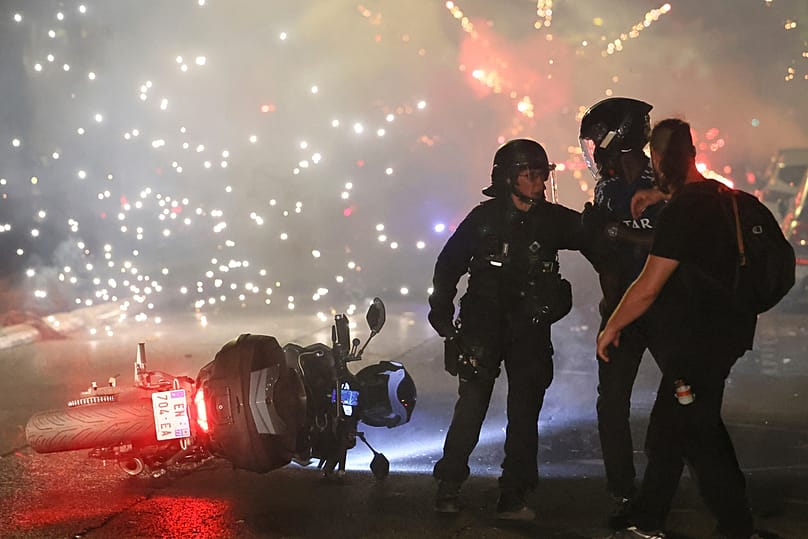 La police tente de disperser des supporters du PSG qui allument des feux d'artifice pour célébrer leur victoire à Paris, samedi 30 mai 2026.