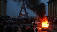 A car burns as PSG supporters celebrate in Paris, Saturday, May 30, 2026 after the Champions League final soccer match between Paris Saint-Germain and Arsenal that's being pla