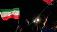 Demonstrators wave Iranian flags during a pro-government gathering at Islamic Revolution Square in Tehran, Iran, Saturday, May 30, 2026.