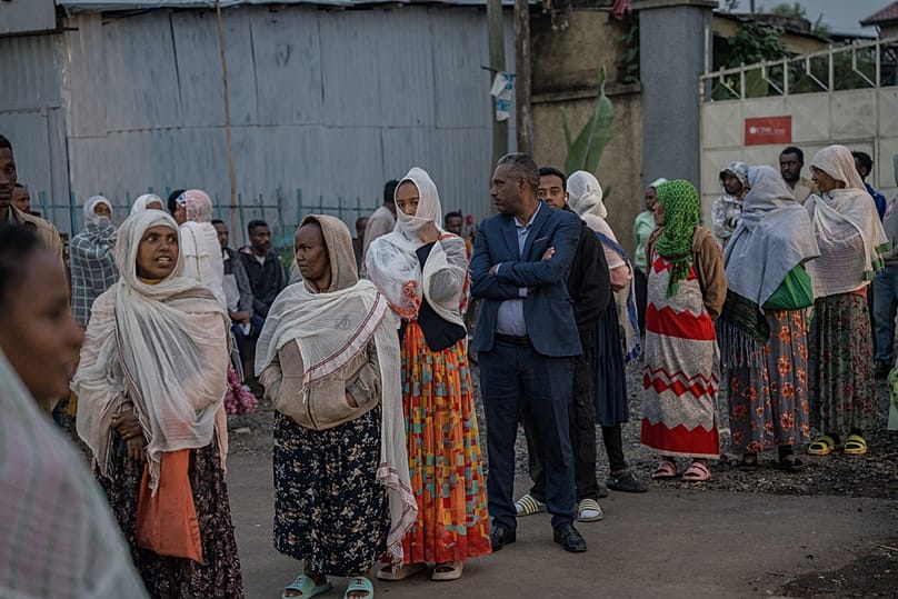 People gather outside a polling station before casting their votes in the general election in Addis Ababa, Ethiopia, Monday, June 1, 2026. 