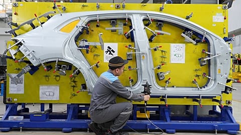 FILE. A worker examines a car frame at a Vinfast factory in Hai Phong, Vietnam, Sept. 2023