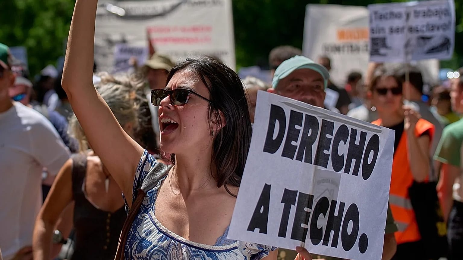 A woman holds a sign reading in Spanish: 'Right to housing' during a protest in Madrid, Spain, on Sunday 24 May 2026.