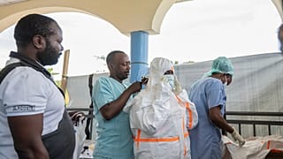 Health workers get ready to start their shift at the Ebola treatment center in Rwampara, Congo, Friday, May 29, 2026.