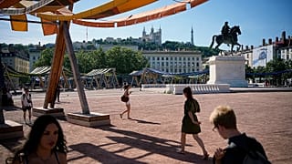 People walk during a heat wave, in Lyon, central France, Friday, May 29, 2026. 