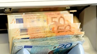 FILE - In this June 22, 2009 file picture a machine counts Euro bank notes in a counter of a bank in Dresden, Germany. 