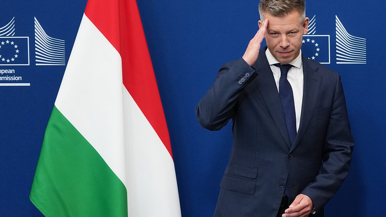 Hungary's Prime Minister Peter Magyar gestures as he is greeted by European Commission President Ursula von der Leyen prior to a meeting at EU headquarters in Brussels, Friday