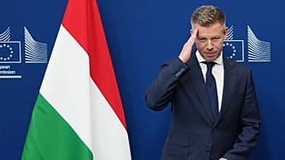 Hungary's Prime Minister Peter Magyar gestures as he is greeted by European Commission President Ursula von der Leyen prior to a meeting at EU headquarters in Brussels, Friday