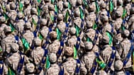 FILE: Iran's Revolutionary Guard members march during an annual military parade near Tehran, 22 September 2023