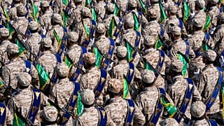 FILE: Iran's Revolutionary Guard members march during an annual military parade near Tehran, 22 September 2023