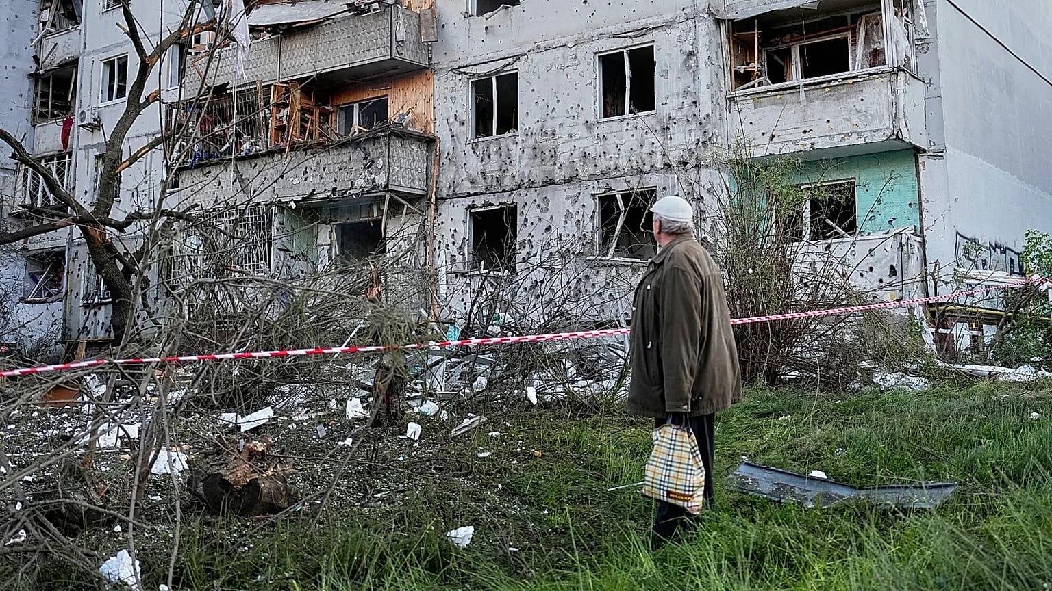 A resident looks at the site of a Russian missile strike that hit a residential building in Kyiv, Ukraine, Tuesday, June 2, 2026. (AP Photo/Efrem Lukatsky)