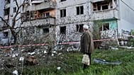 A resident looks at the site of a Russian missile strike that hit a residential building in Kyiv, Ukraine, Tuesday, June 2, 2026. (AP Photo/Efrem Lukatsky)