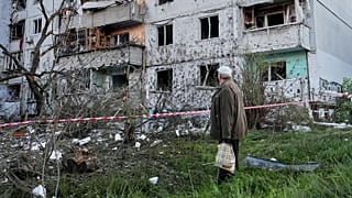 A resident looks at the site of a Russian missile strike that hit a residential building in Kyiv, Ukraine, Tuesday, June 2, 2026. (AP Photo/Efrem Lukatsky)