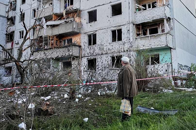 A resident looks at the site of a Russian missile strike that hit a residential building in Kyiv, Ukraine, Tuesday, June 2, 2026.