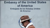 FILE- A man waits in line to enter the U.S. embassy after visa processing services had been suspended for various days in Bogota, Colombia, Friday, Jan. 31, 2025. (AP Photo/Fe