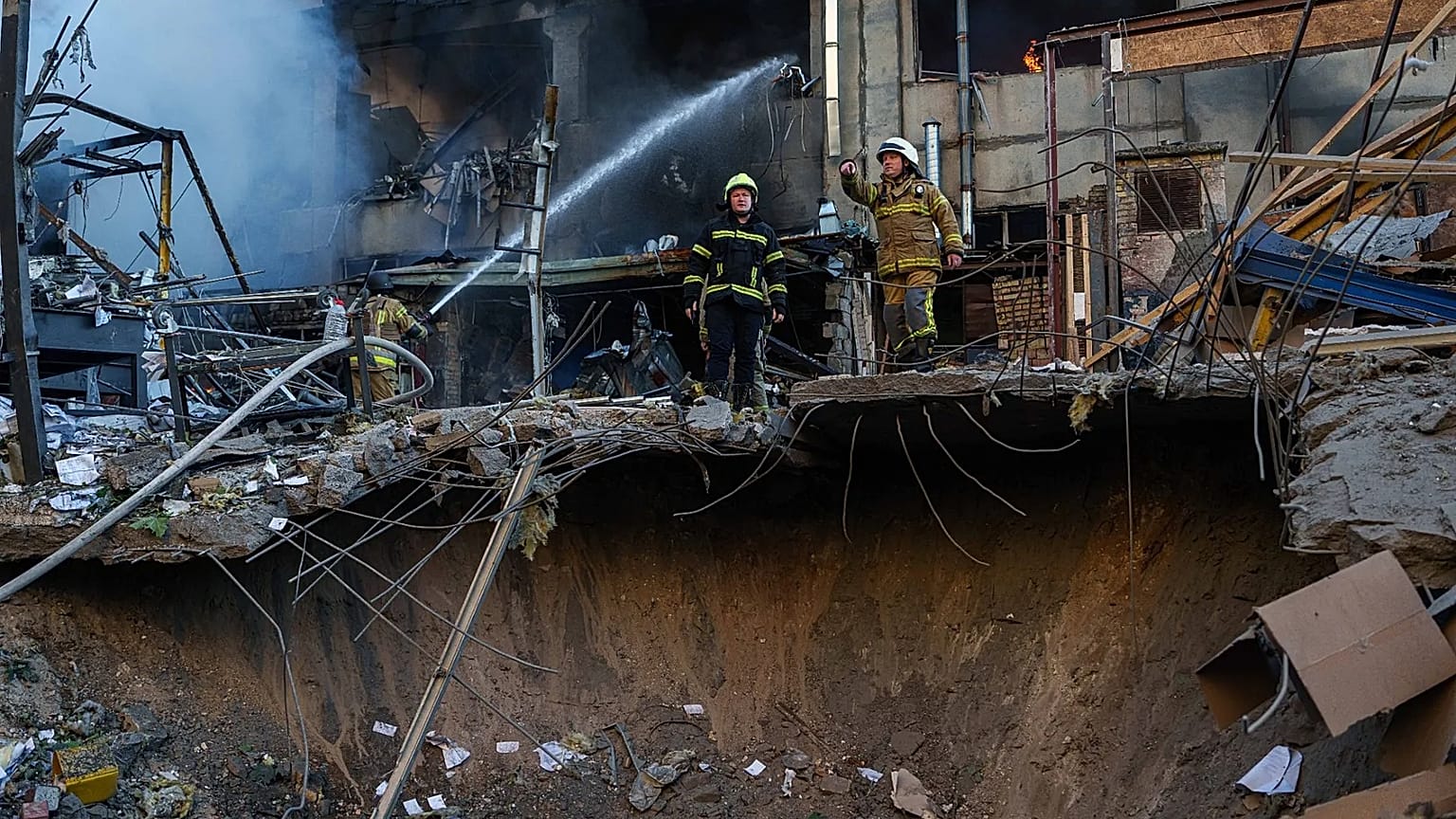 A rescue worker puts out a fire of a building damaged after a Russian strike on Kyiv, 2 June, 2026