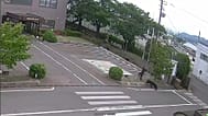 This image made from the security camera footage provided by the Fukushima Steel Works shows a bear chasing a person on its premises in Fukushima, 2 June, 2026