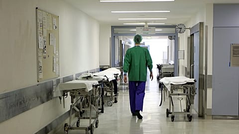 FILE - A doctor walks through an almost deserted floor of the surgery station at the University Hospital in Bonn. March 16, 2006.