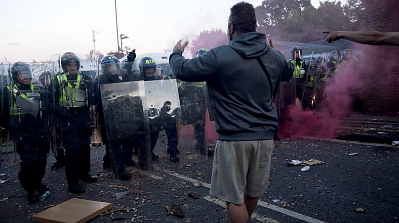 In this image taken from PA Video, police and protestors clash during a protest following the death of Henry Nowak, a 18-year-old student stabbed to death.